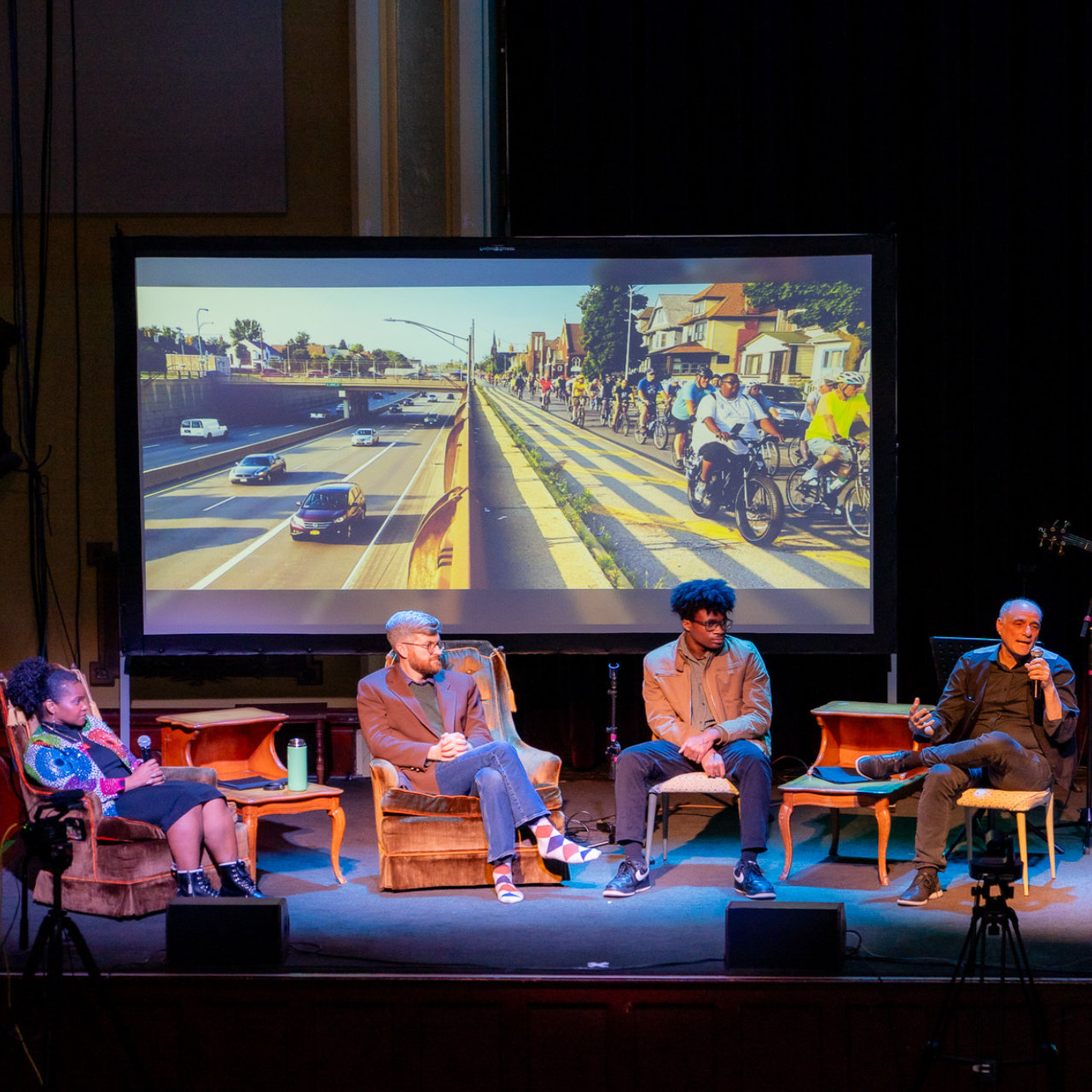 People sitting on stage talking at event - Square images